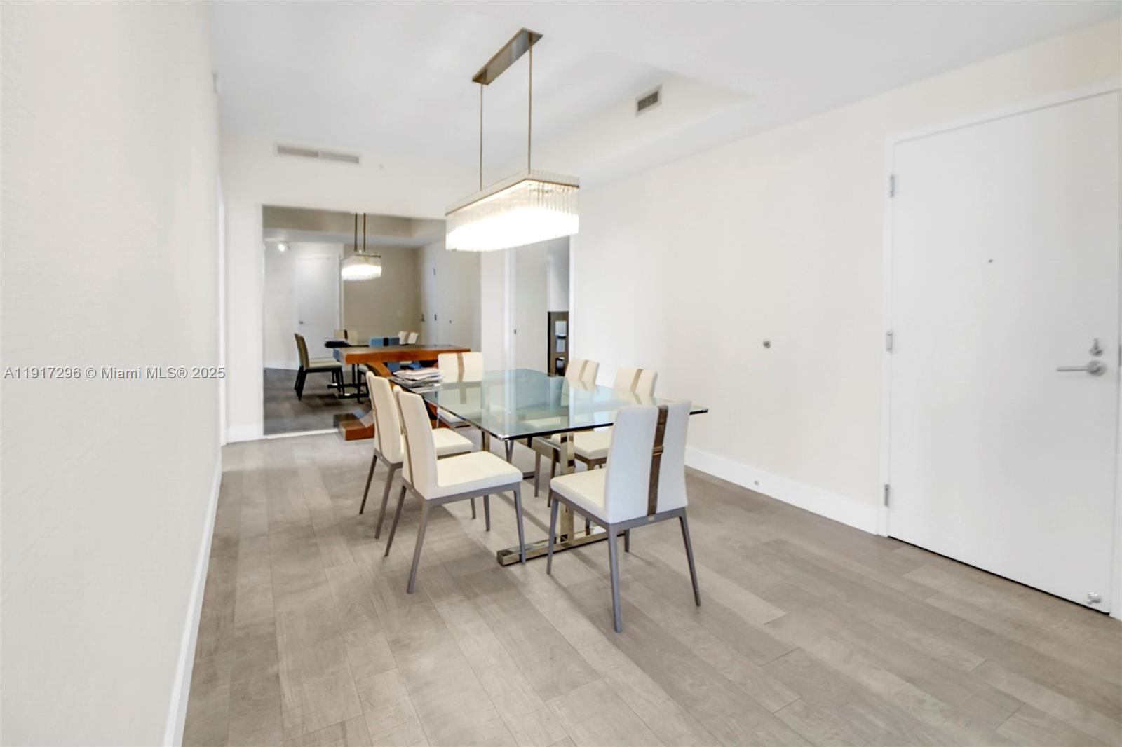 2900 Northeast 7th Avenue, Unit 1807 Miami, FL 33137 - Photo 26 of 36 a view of a dining room with furniture and a chandelier