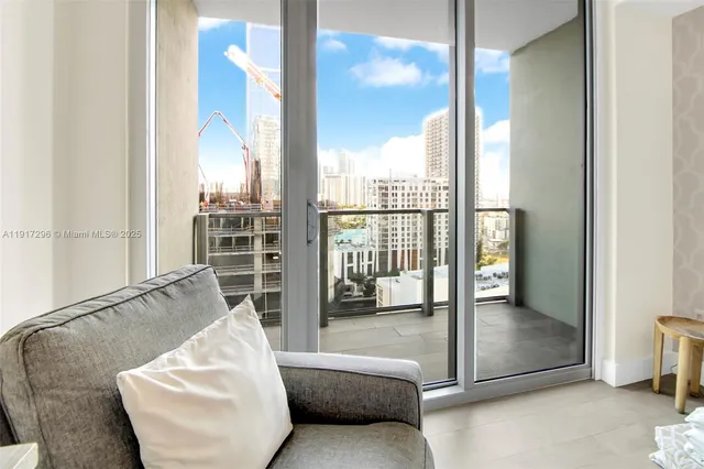 a bedroom with bed and a flat tv screen next to a window