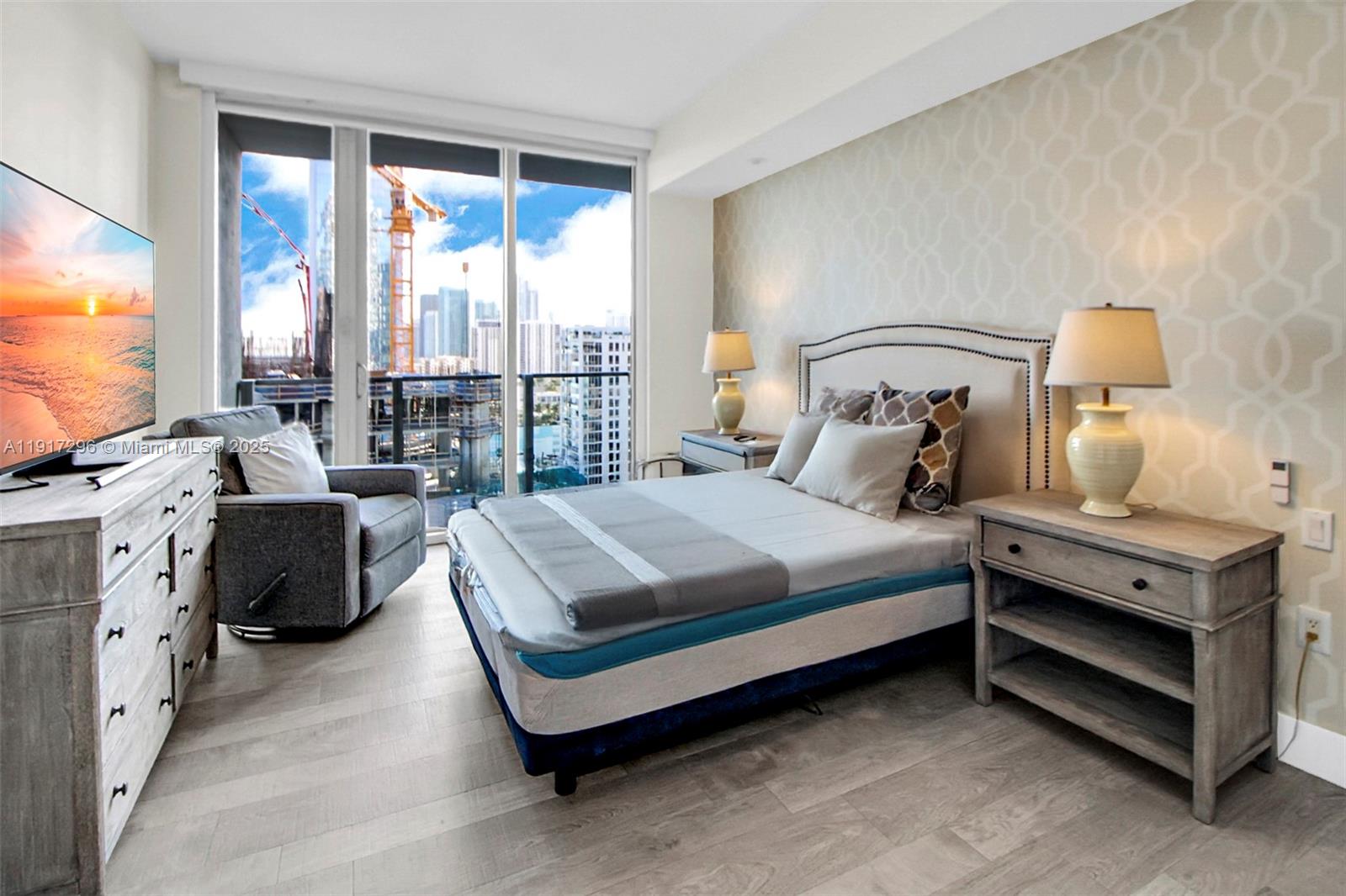 2900 Northeast 7th Avenue, Unit 1807 Miami, FL 33137 - Photo 31 of 36 a bedroom with bed and a flat tv screen next to a window