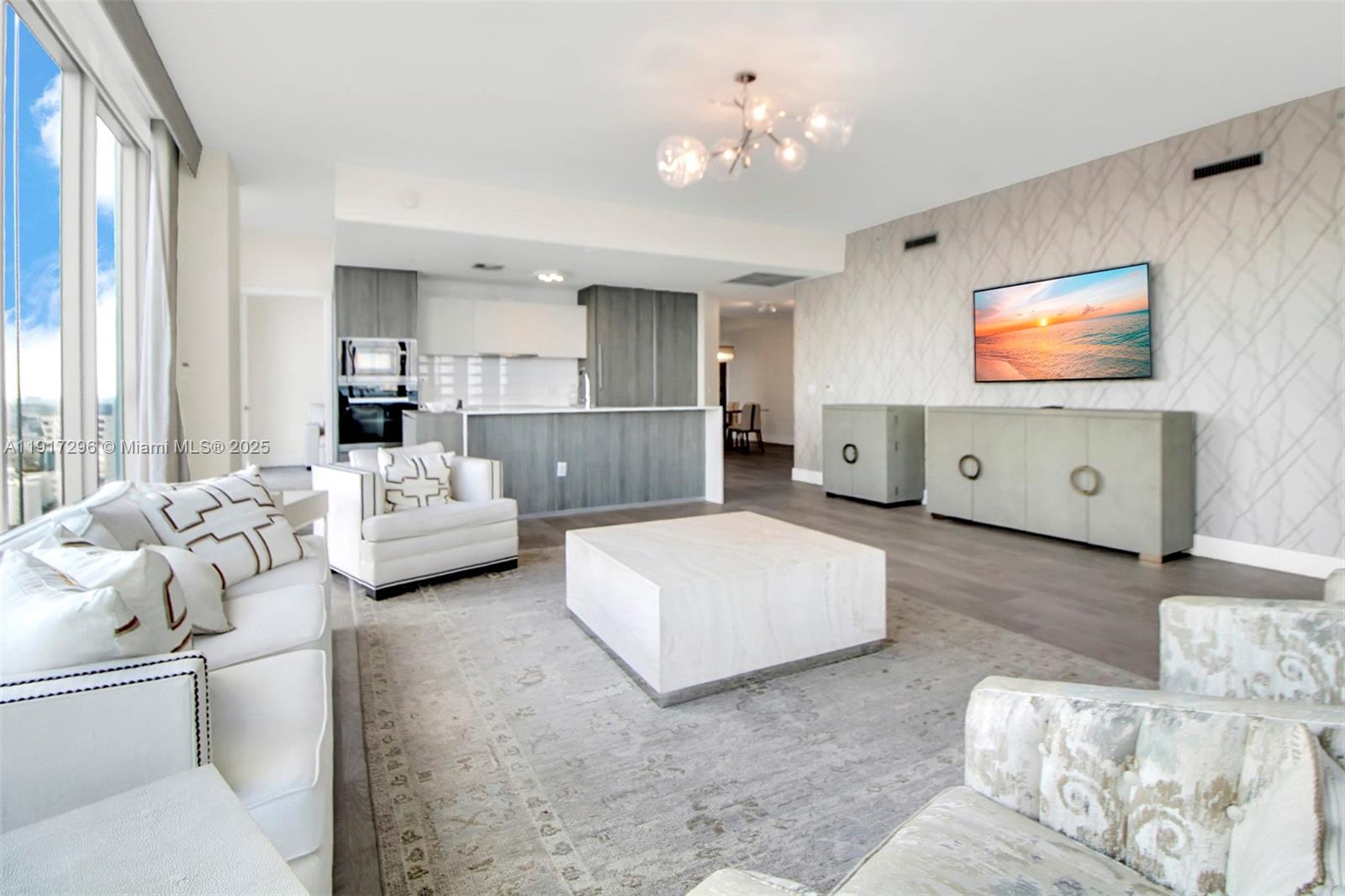 2900 Northeast 7th Avenue, Unit 1807 Miami, FL 33137 - Photo 5 of 36 a living room with furniture and a flat screen tv