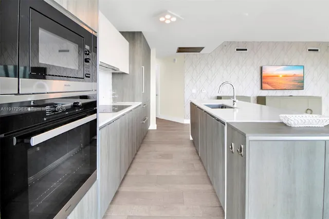 a kitchen with stainless steel appliances a stove sink and cabinets