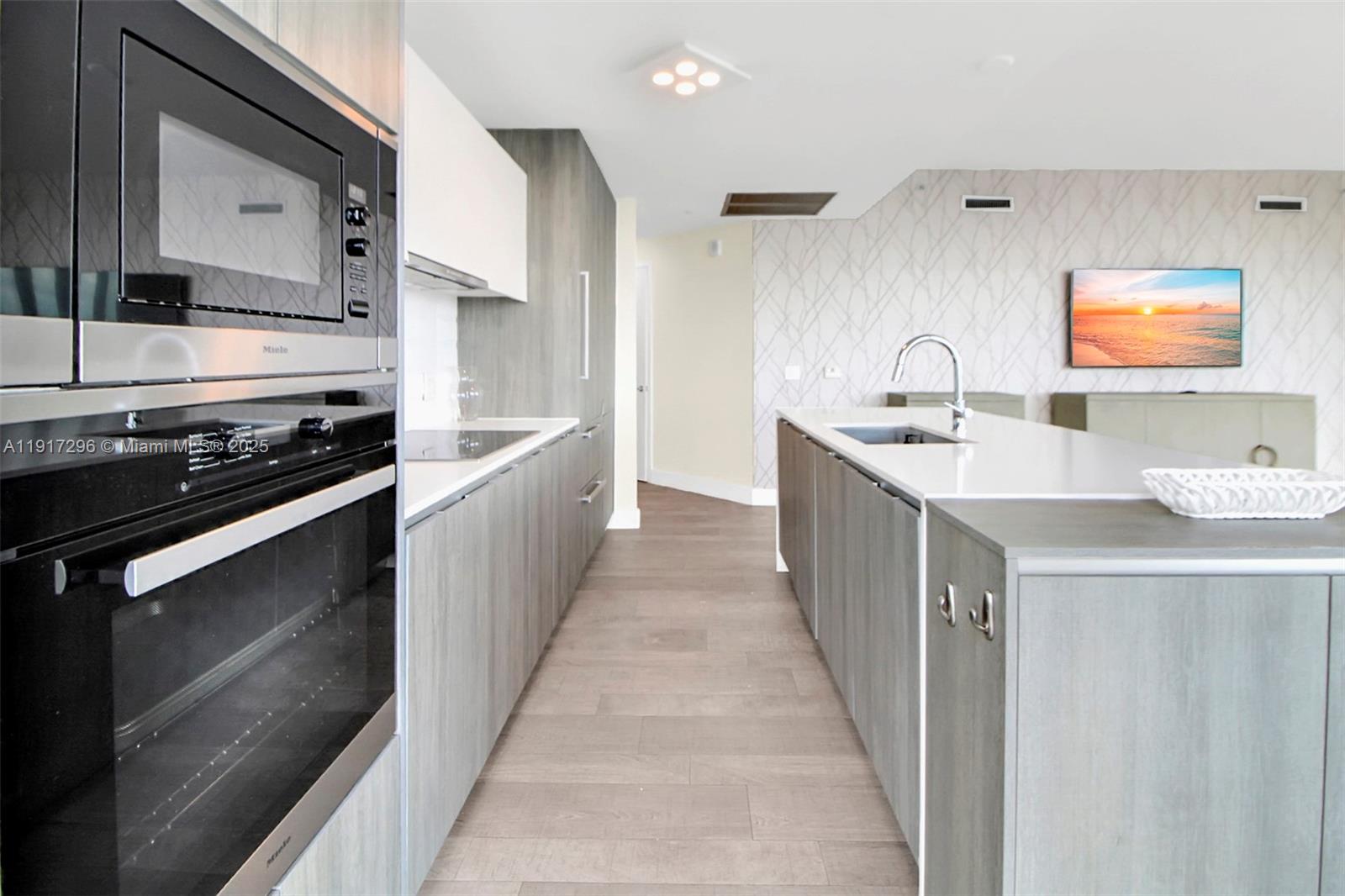 2900 Northeast 7th Avenue, Unit 1807 Miami, FL 33137 - Photo 8 of 36 a kitchen with stainless steel appliances a stove sink and cabinets