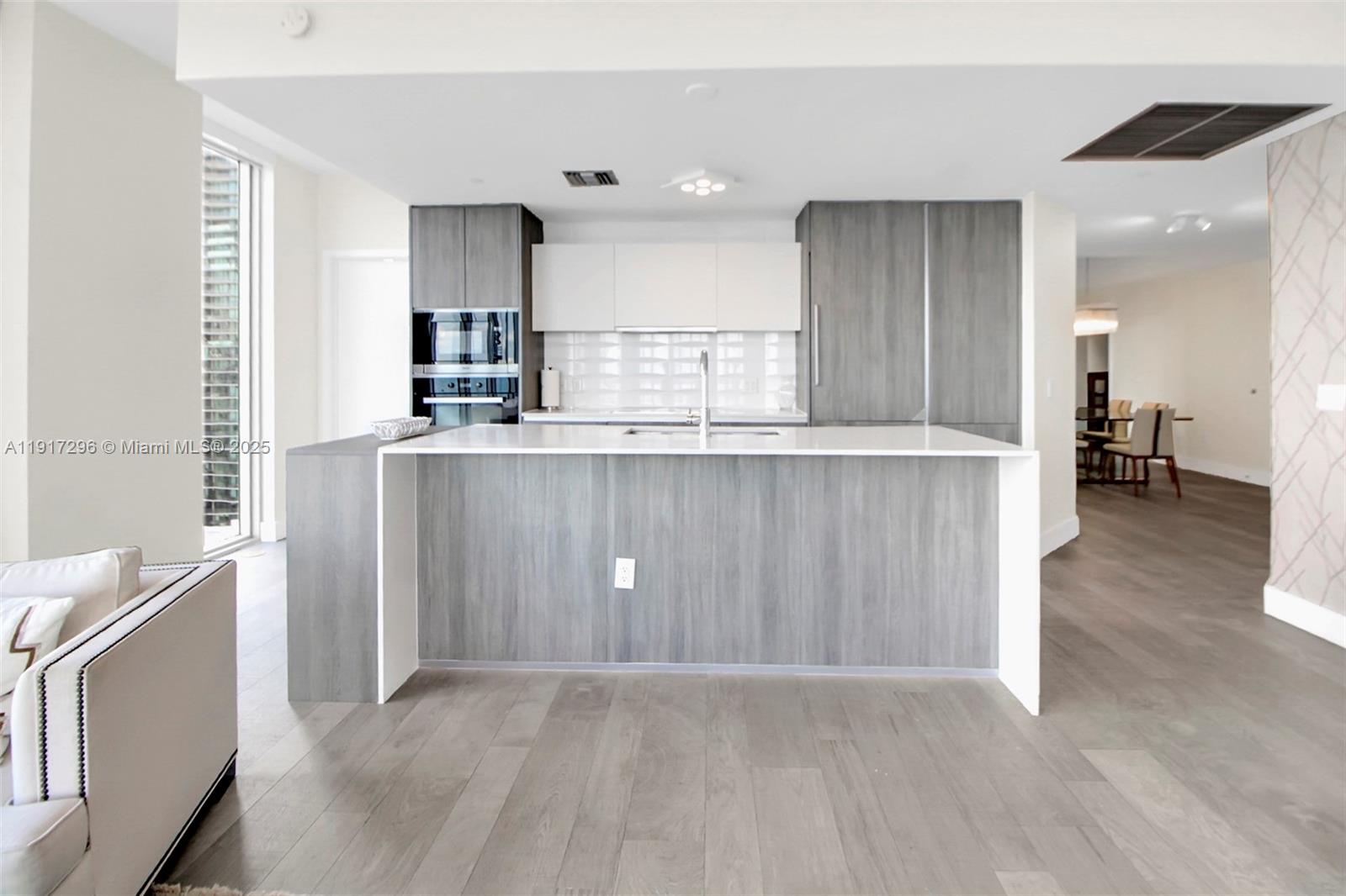 2900 Northeast 7th Avenue, Unit 1807 Miami, FL 33137 - Photo 9 of 36 a view of kitchen with wooden floor