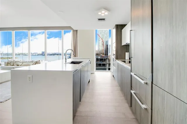 a kitchen with stainless steel appliances a refrigerator and a stove