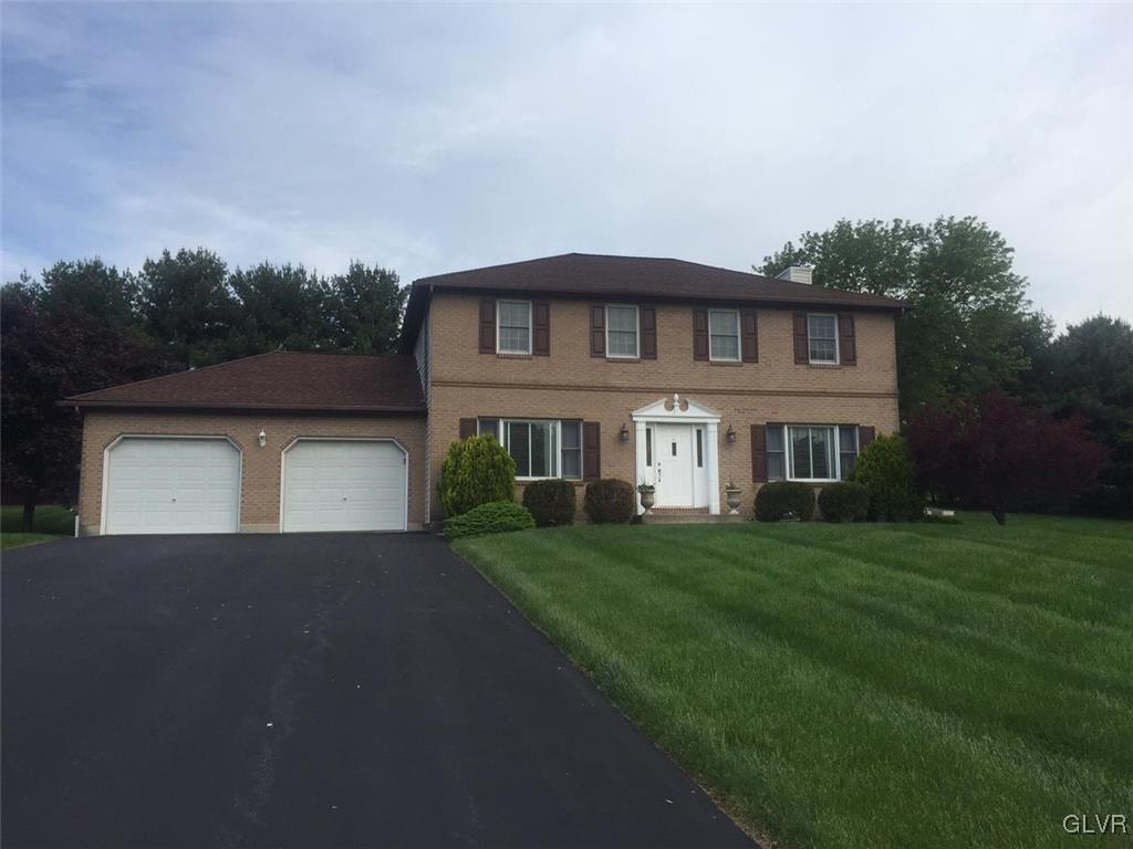 138 West Aluta Mill Road Nazareth, PA 18064 - Photo 1 of 13 a front view of a house with a yard and garage