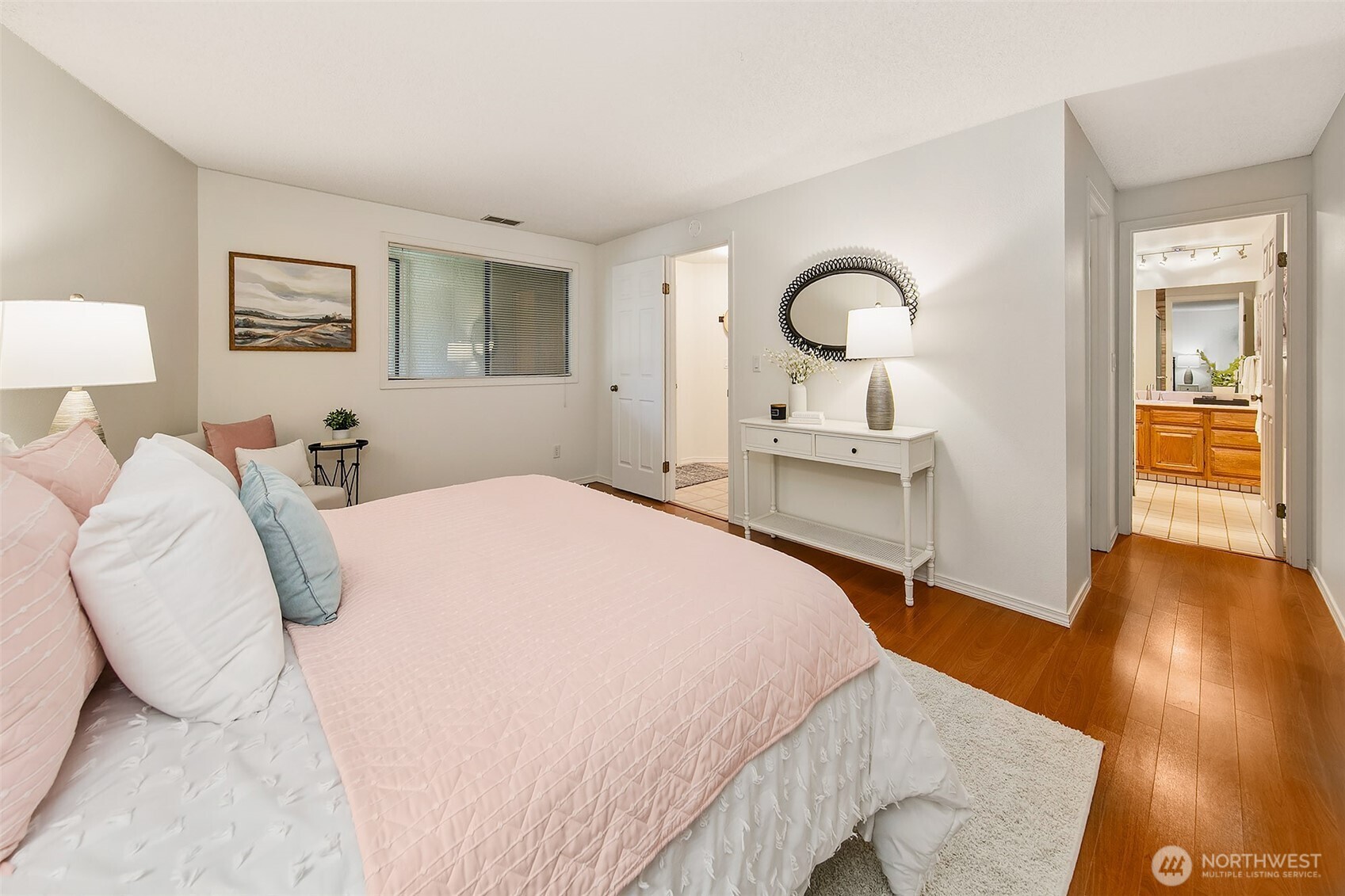 16929 Inglewood Road Northeast, Unit C305 Kenmore, WA 98028 - Photo 14 of 27 a bedroom with a bed and a wooden floor