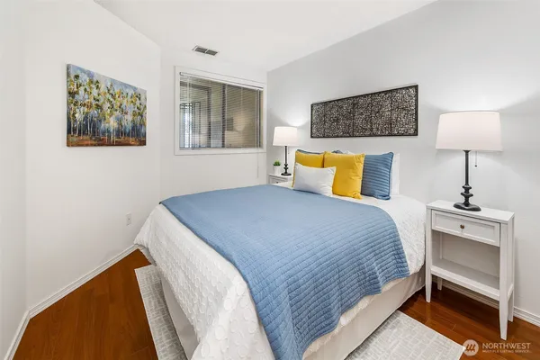 a bedroom with a bed and wall painting