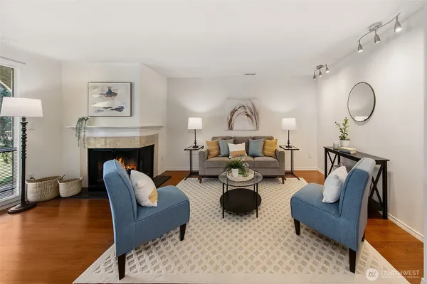 a living room with furniture a fireplace and a chandelier