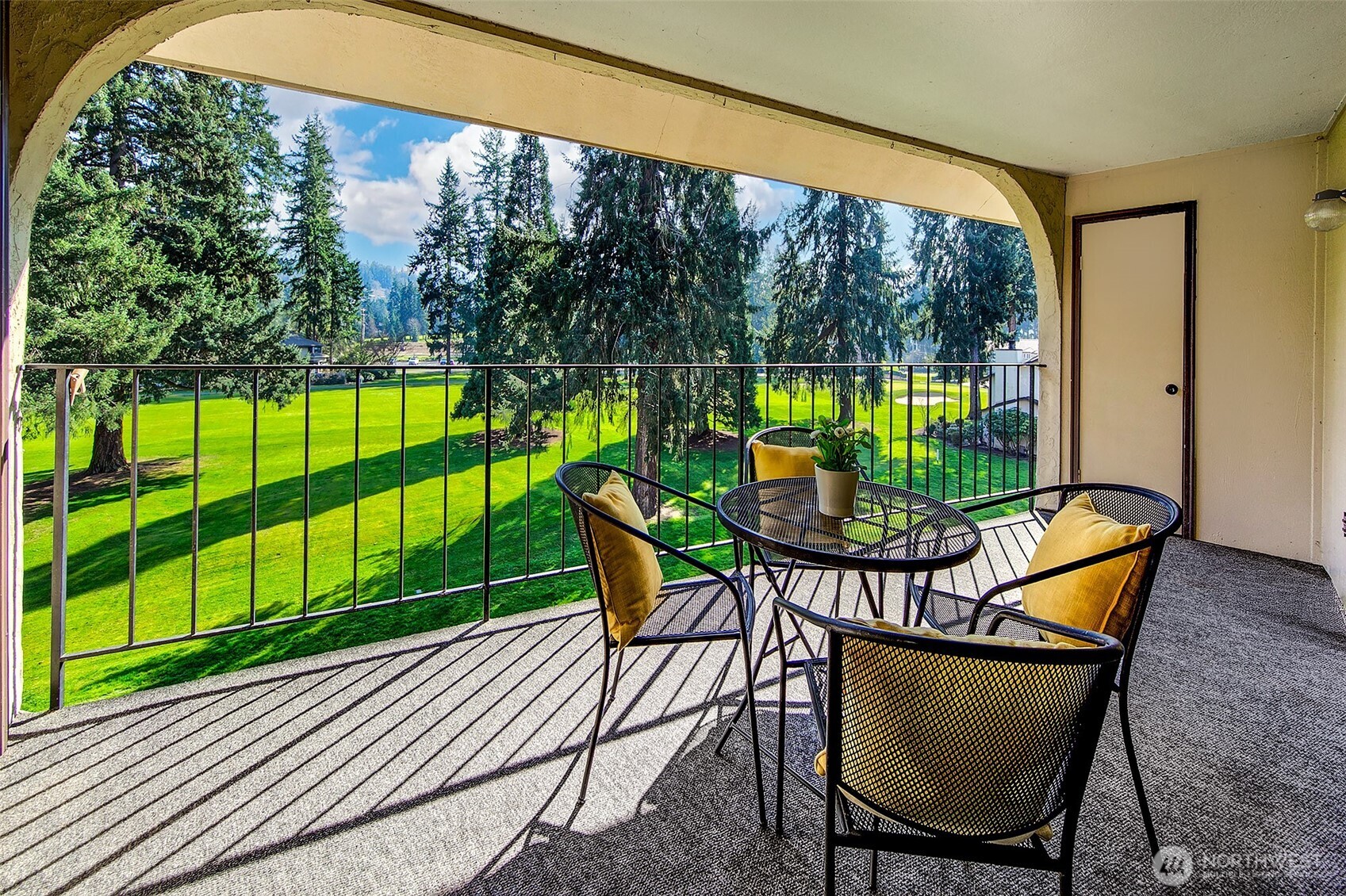 16929 Inglewood Road Northeast, Unit C305 Kenmore, WA 98028 - Photo 9 of 27 a view of a chairs and table in the balcony