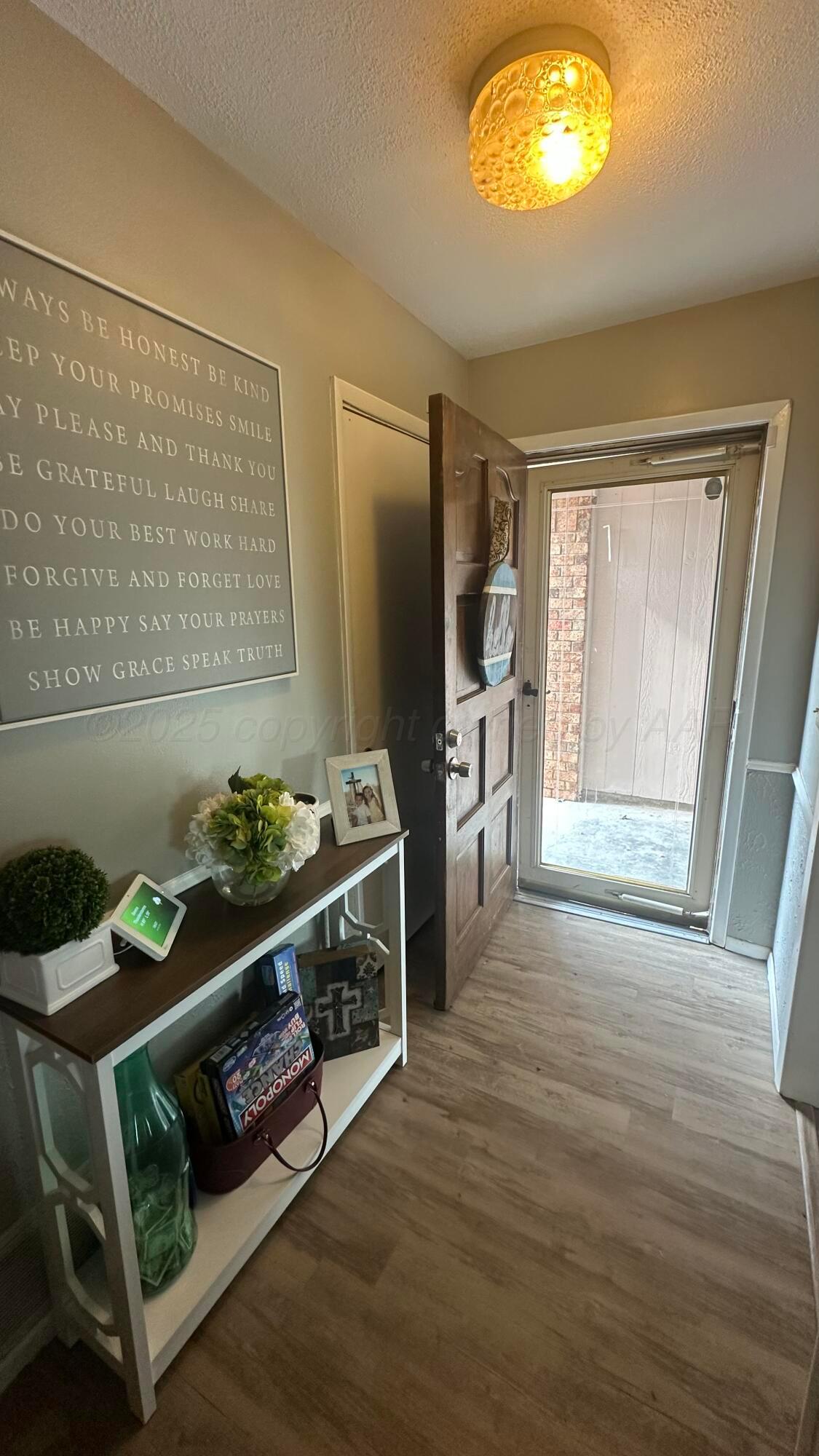 4825 South Austin Street Amarillo, TX 79110 - Photo 3 of 12 a living room with furniture and a flat screen tv