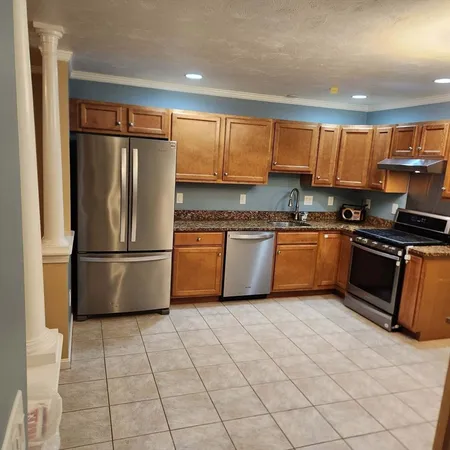 a kitchen with stainless steel appliances granite countertop a refrigerator sink and cabinets