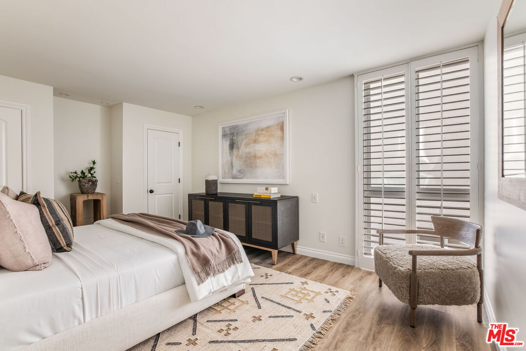 30 Driftwood Street, Unit 4 Marina del Rey, CA 90292 - Photo 12 of 19 a bedroom with a bed and a dresser with wooden floor