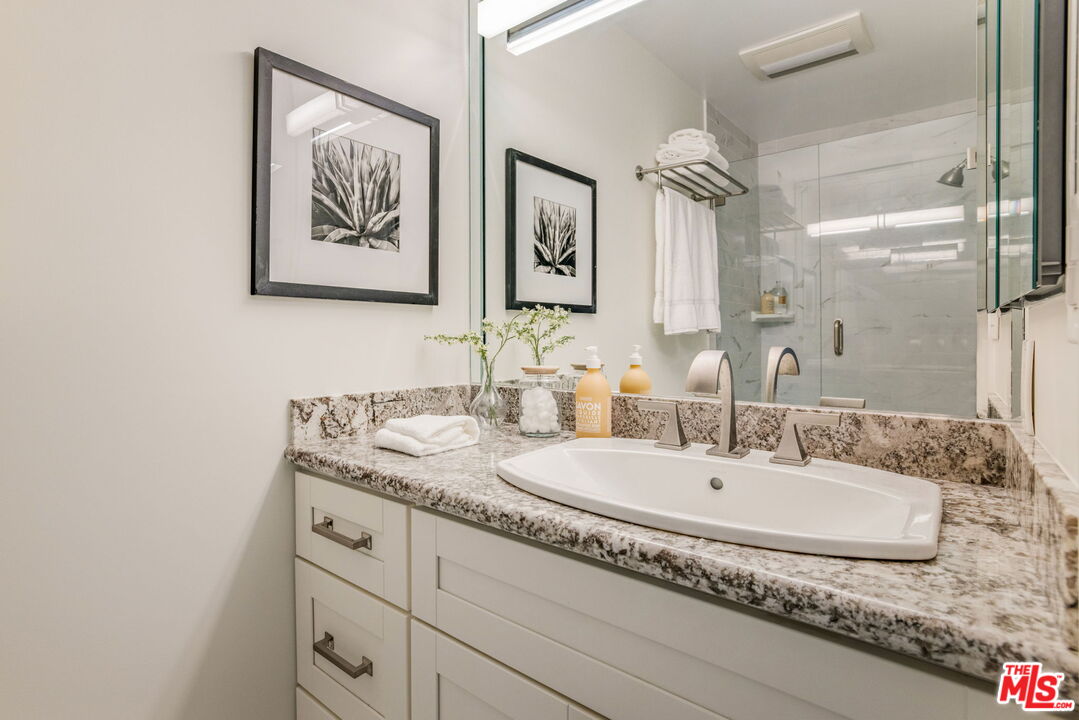 30 Driftwood Street, Unit 4 Marina del Rey, CA 90292 - Photo 13 of 19 a bathroom with a granite countertop sink and a mirror