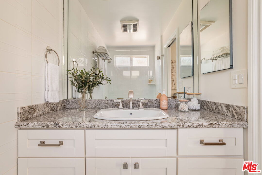 30 Driftwood Street, Unit 4 Marina del Rey, CA 90292 - Photo 17 of 19 a bathroom with sink granite and mirror