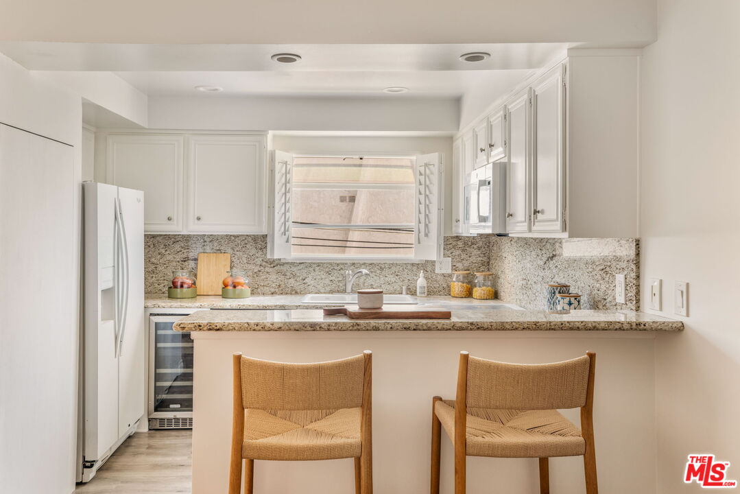 30 Driftwood Street, Unit 4 Marina del Rey, CA 90292 - Photo 8 of 19 a kitchen with stainless steel appliances granite countertop a sink and cabinets