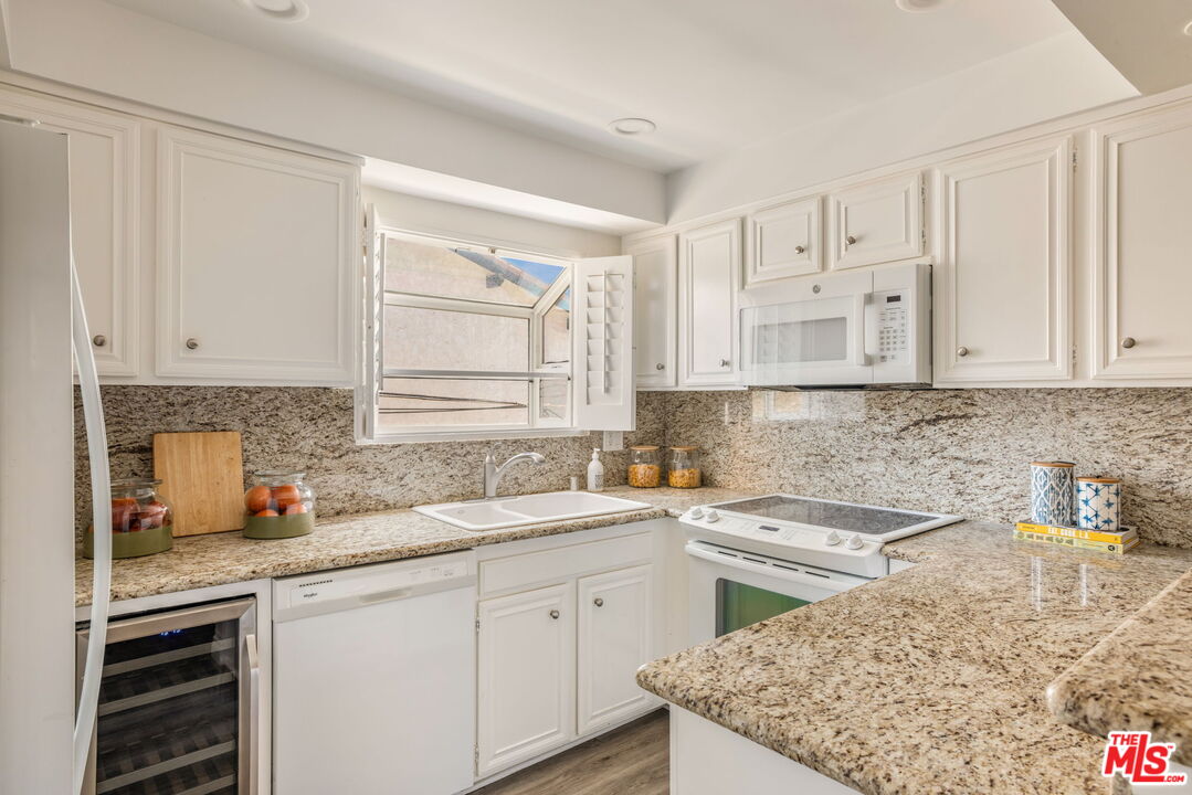 30 Driftwood Street, Unit 4 Marina del Rey, CA 90292 - Photo 9 of 19 a kitchen with stainless steel appliances granite countertop a sink stove and cabinets