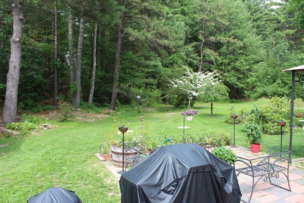 21 Mulpus Road Lunenburg, MA 01462 - Photo 16 of 24 a view of backyard with table and chairs and potted plants