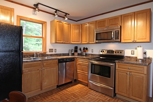 21 Mulpus Road Lunenburg, MA 01462 - Photo 2 of 24 a kitchen with stainless steel appliances granite countertop a stove a sink and a microwave