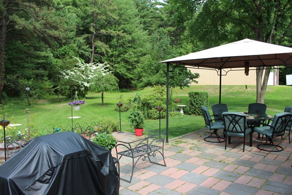 21 Mulpus Road Lunenburg, MA 01462 - Photo 21 of 24 a view of a table and chairs under an umbrella