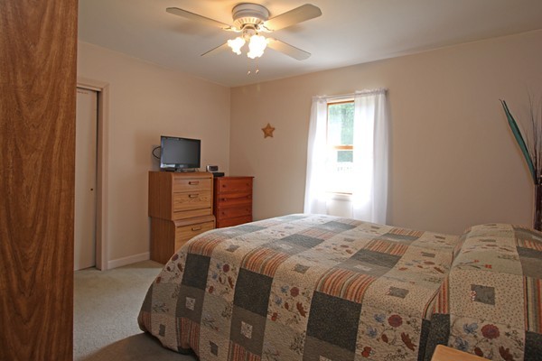 21 Mulpus Road Lunenburg, MA 01462 - Photo 7 of 24 a bedroom with a bed and a chandelier