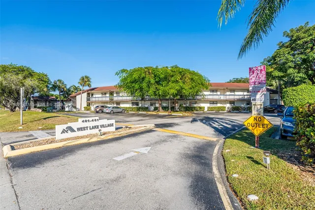 a view of swimming pool with outdoor seating and plants