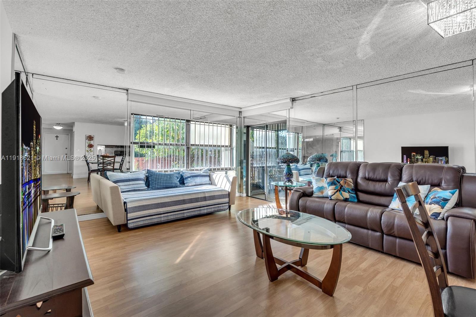 401 Northwest 107th Avenue, Unit 107 Miami, FL 33172 - Photo 12 of 31 a living room with furniture and a flat screen tv