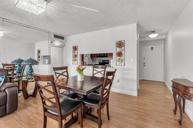 a living room with furniture a flat screen tv and a large window