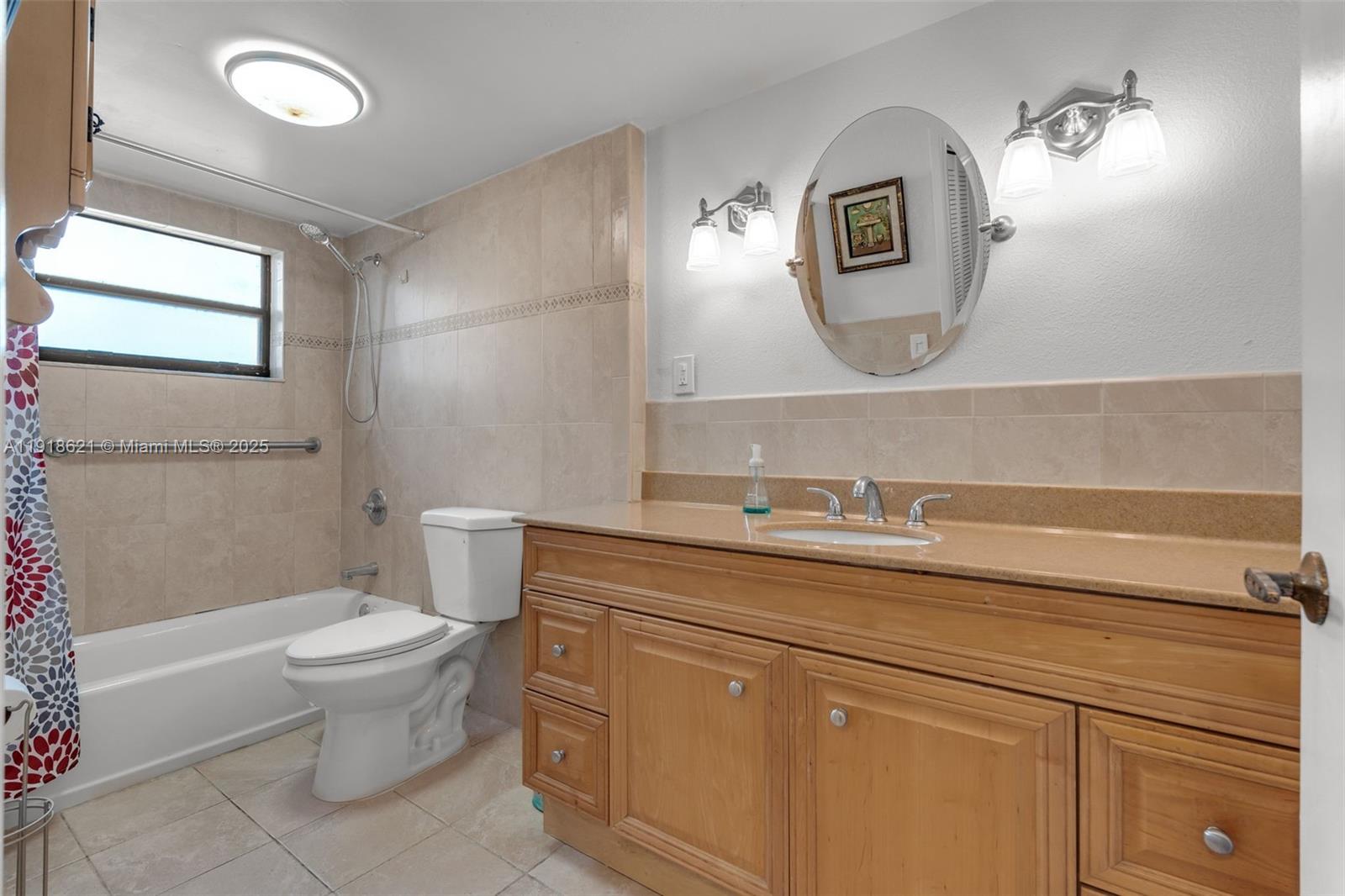 401 Northwest 107th Avenue, Unit 107 Miami, FL 33172 - Photo 19 of 31 a bathroom with a toilet a sink and mirror