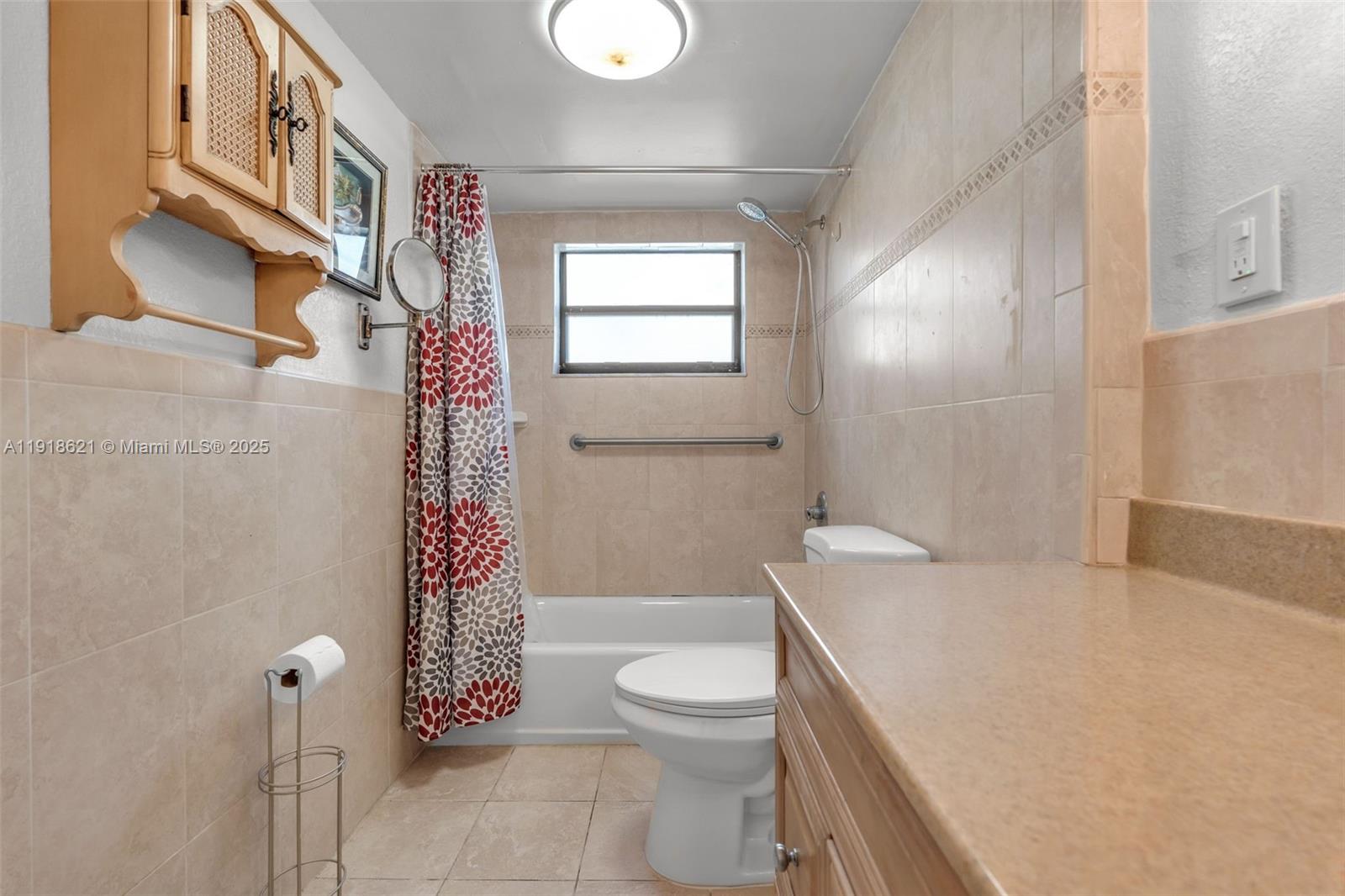 401 Northwest 107th Avenue, Unit 107 Miami, FL 33172 - Photo 20 of 31 a bathroom with a granite countertop toilet a sink and a shower