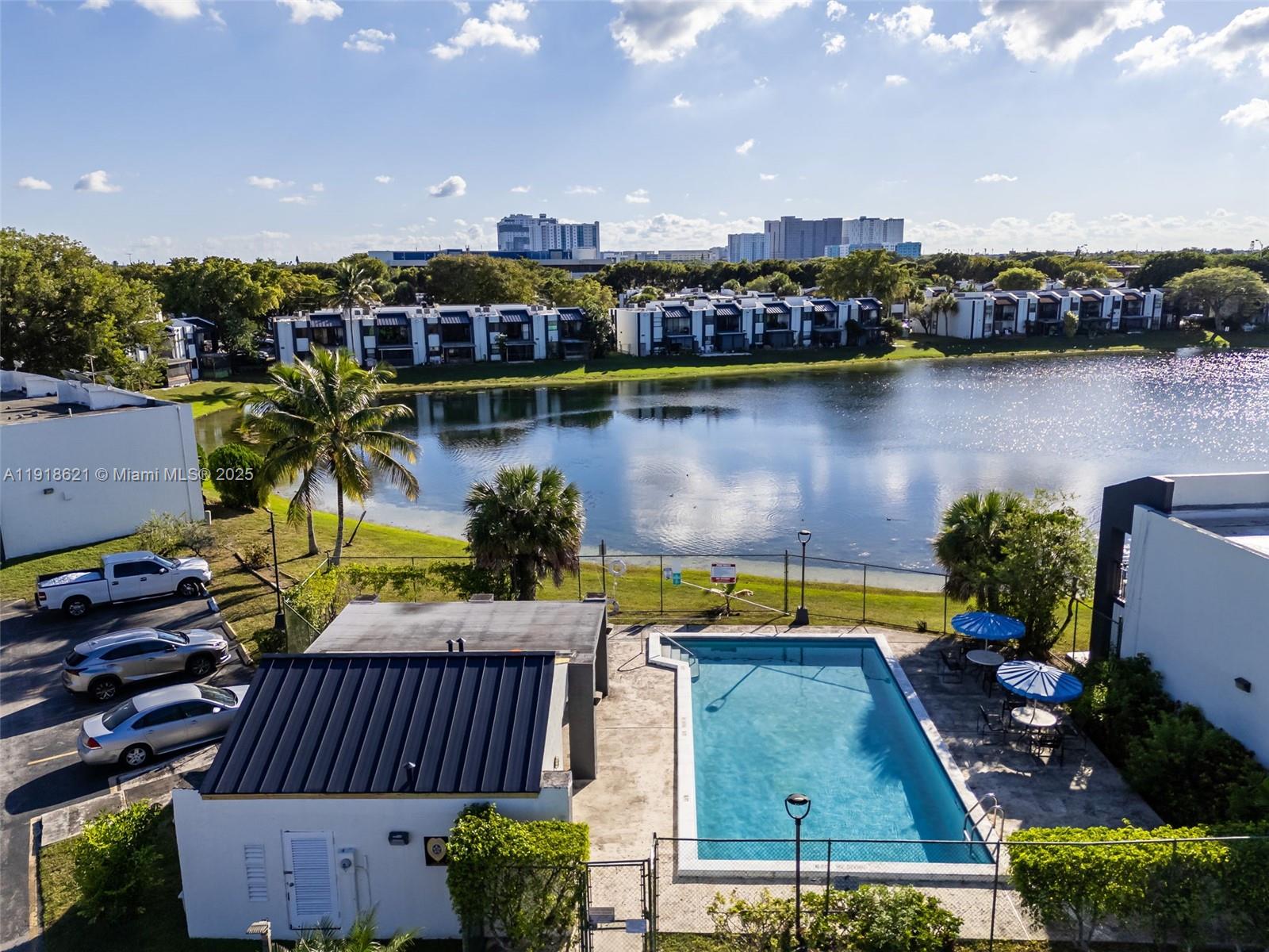 401 Northwest 107th Avenue, Unit 107 Miami, FL 33172 - Photo 28 of 31 a view of a swimming pool with a lounge chairs