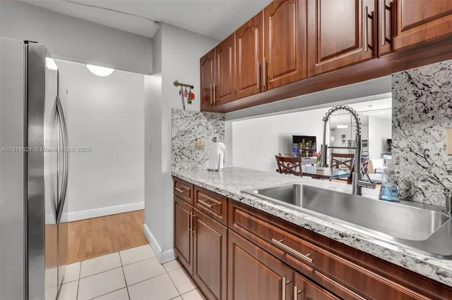 a kitchen with granite countertop sink and cabinets