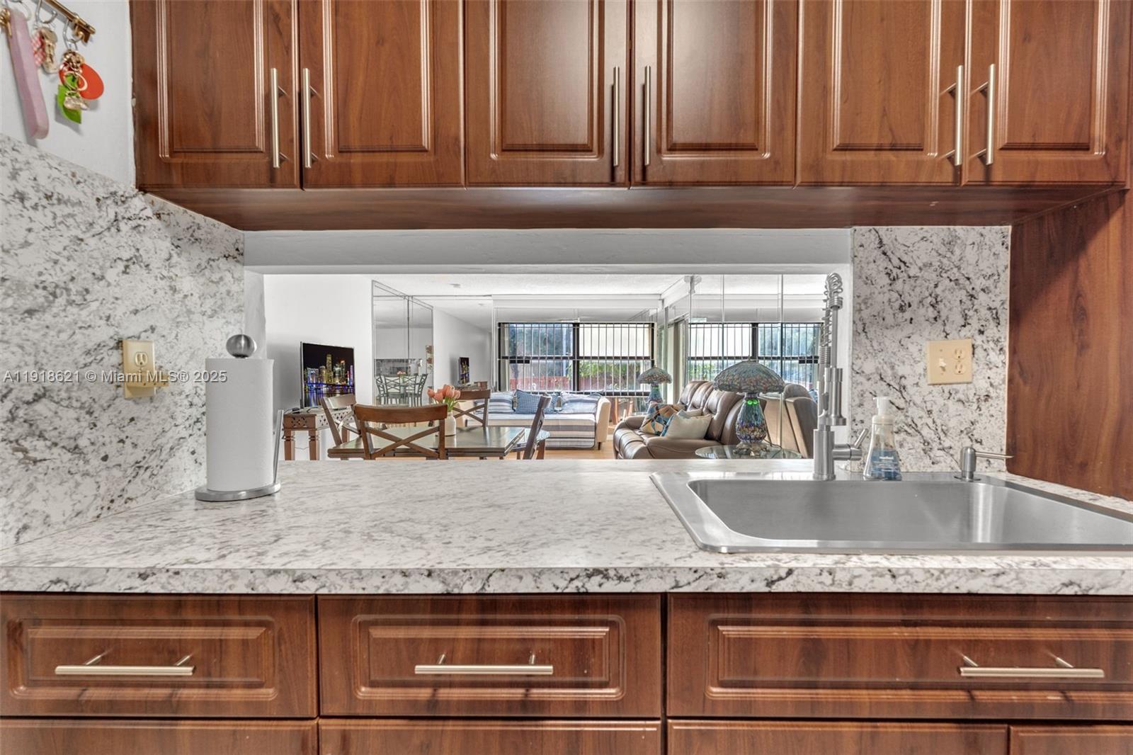 401 Northwest 107th Avenue, Unit 107 Miami, FL 33172 - Photo 8 of 31 a kitchen with granite countertop sink and cabinets