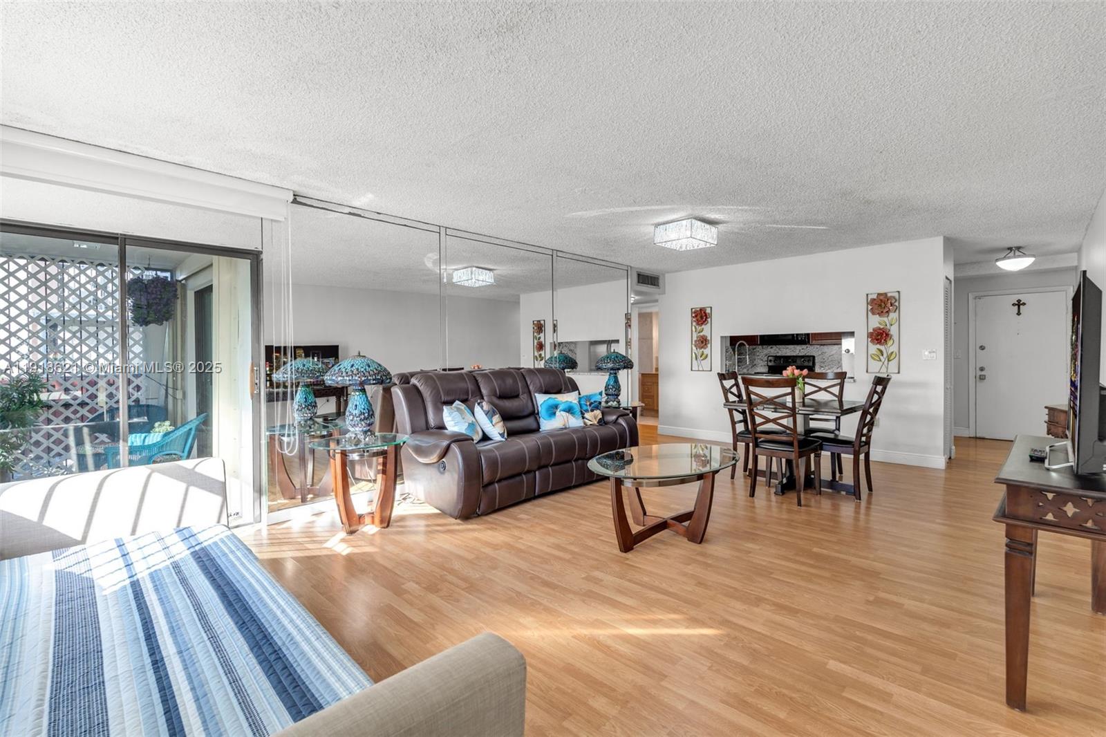 401 Northwest 107th Avenue, Unit 107 Miami, FL 33172 - Photo 9 of 31 a living room with lots of furniture and kitchen view
