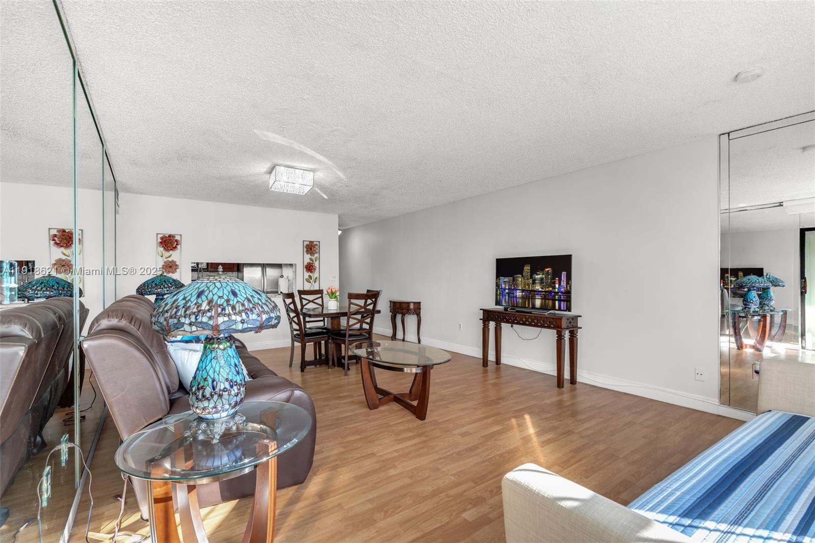 401 Northwest 107th Avenue, Unit 107 Miami, FL 33172 - Photo 10 of 31 a living room with furniture and a wooden floor