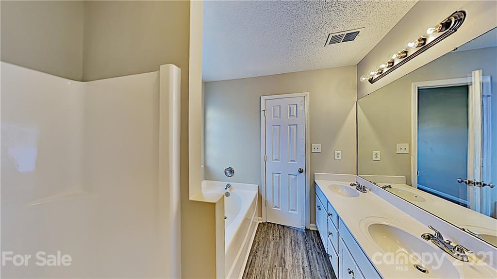 825 Raindrops Road Gastonia, NC 28054 - Photo 14 of 23 a bathroom with a double vanity sink and mirror