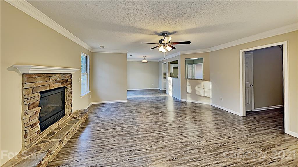825 Raindrops Road Gastonia, NC 28054 - Photo 3 of 23 a view of a livingroom with wooden floor and a kitchen