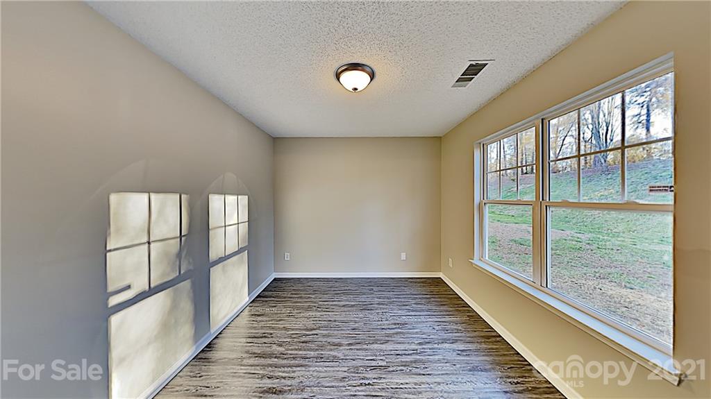 825 Raindrops Road Gastonia, NC 28054 - Photo 22 of 23 a view of empty room with wooden floor and fan