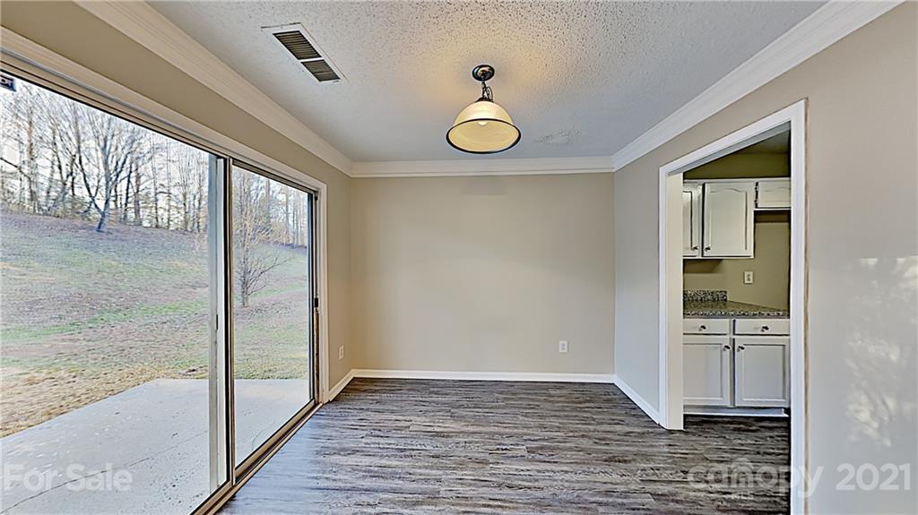 825 Raindrops Road Gastonia, NC 28054 - Photo 6 of 23 a view of a hallway view with wooden floor and staircase