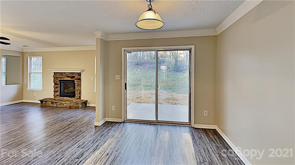 825 Raindrops Road Gastonia, NC 28054 - Photo 7 of 23 an empty room with wooden floor and windows
