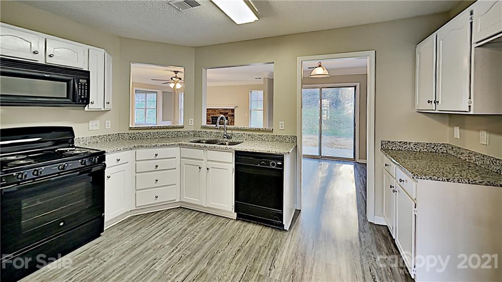 825 Raindrops Road Gastonia, NC 28054 - Photo 8 of 23 a kitchen with stainless steel appliances granite countertop a stove and a sink