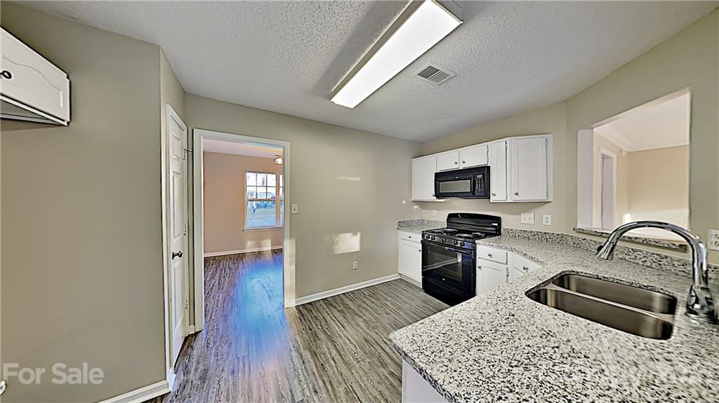 825 Raindrops Road Gastonia, NC 28054 - Photo 9 of 23 a kitchen with a refrigerator stove and sink
