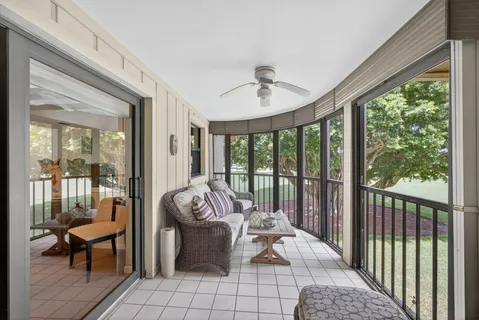 a living room with furniture and a floor to ceiling window