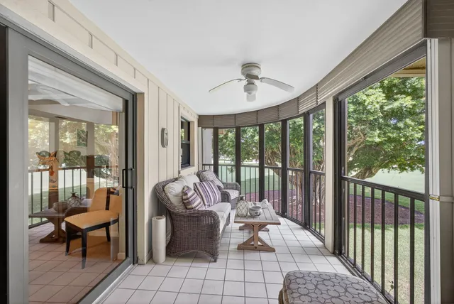 a living room with furniture and a floor to ceiling window