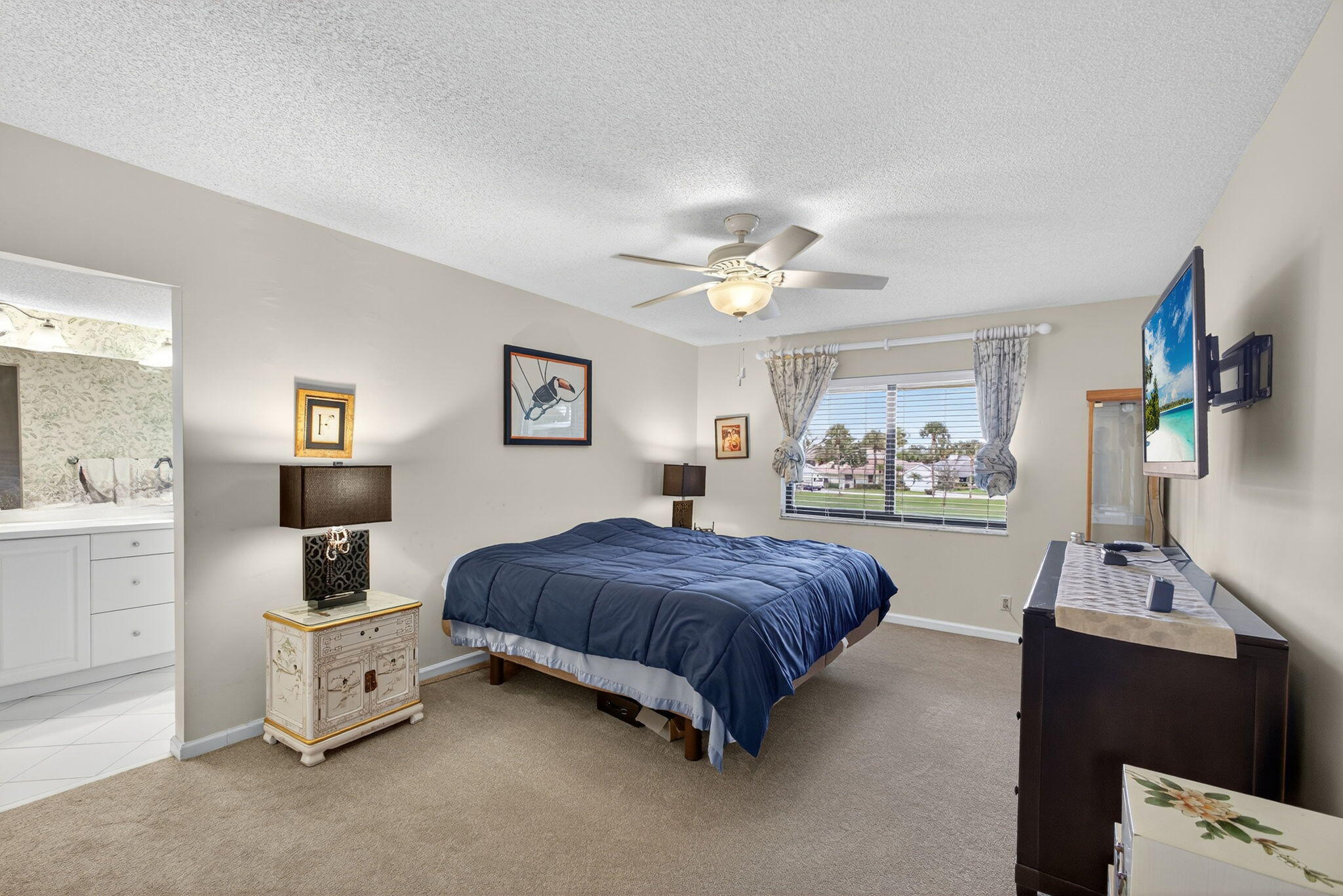 16942 Waterbend Drive, Unit 258 Jupiter, FL 33477 - Photo 18 of 33 a bedroom with a bed and a chandelier