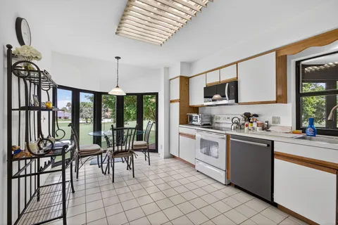 a kitchen with stainless steel appliances granite countertop a stove and a sink