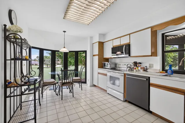 a kitchen with stainless steel appliances granite countertop a stove and a sink