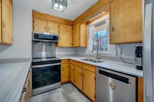 a kitchen with a sink stove and cabinets