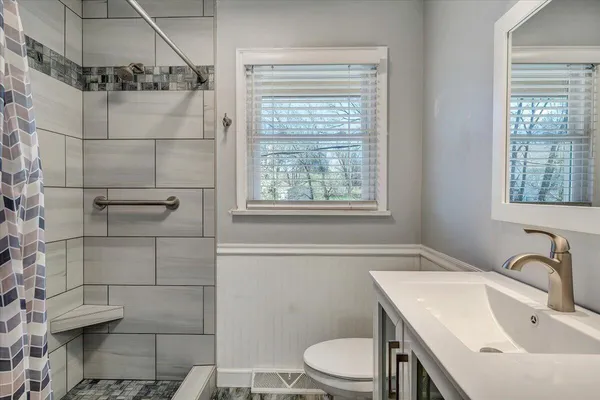 a bathroom with a sink toilet and shower