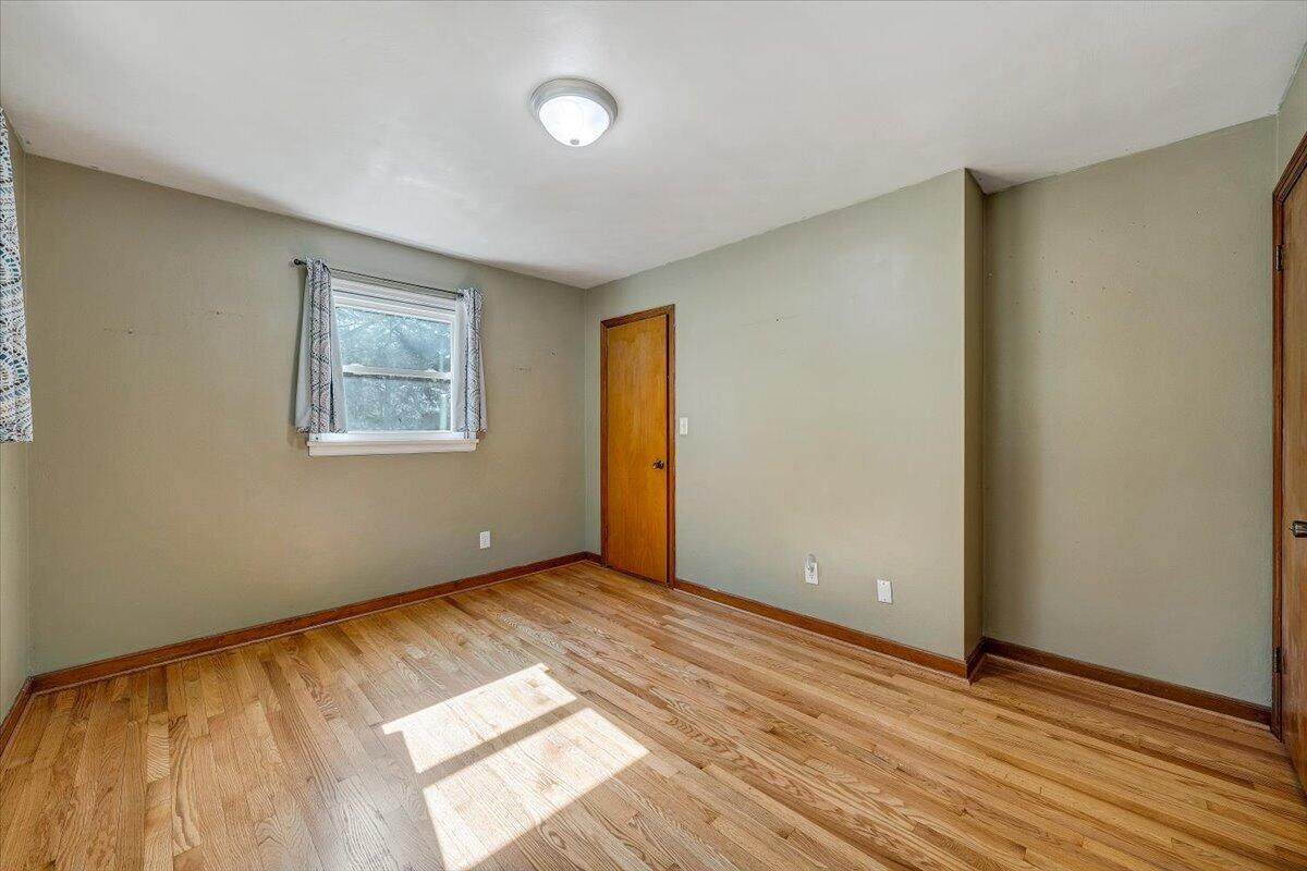 2129 Twelve Oclock Knob Road Salem, VA 24153 - Photo 21 of 48 an empty room with wooden floor and windows