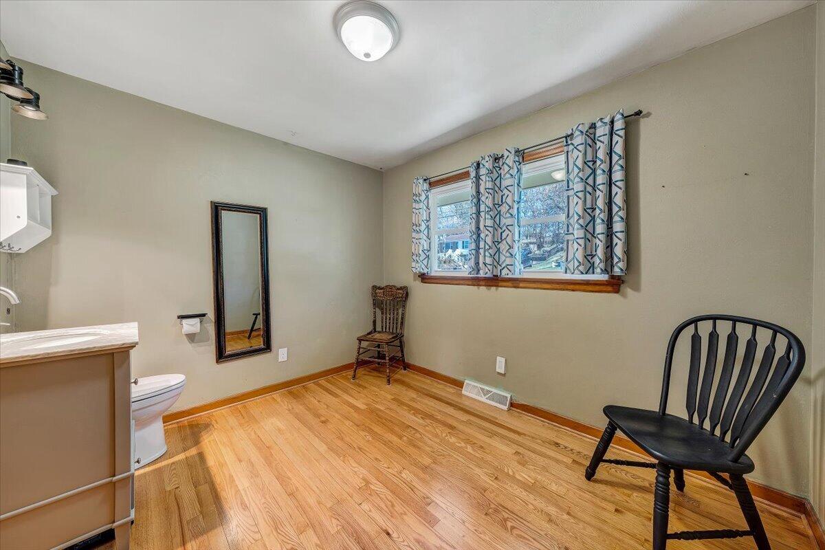 2129 Twelve Oclock Knob Road Salem, VA 24153 - Photo 22 of 48 a bedroom with a chair and wooden floor